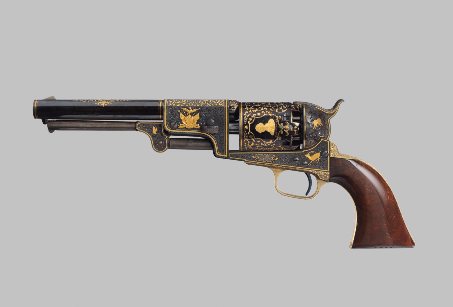 Colt Third Model Dragoon percussion revolver, serial no. 12406: blued steel inlaid with gold scrollwork, an American eagle, and a portrait of George Washington on the cylinder