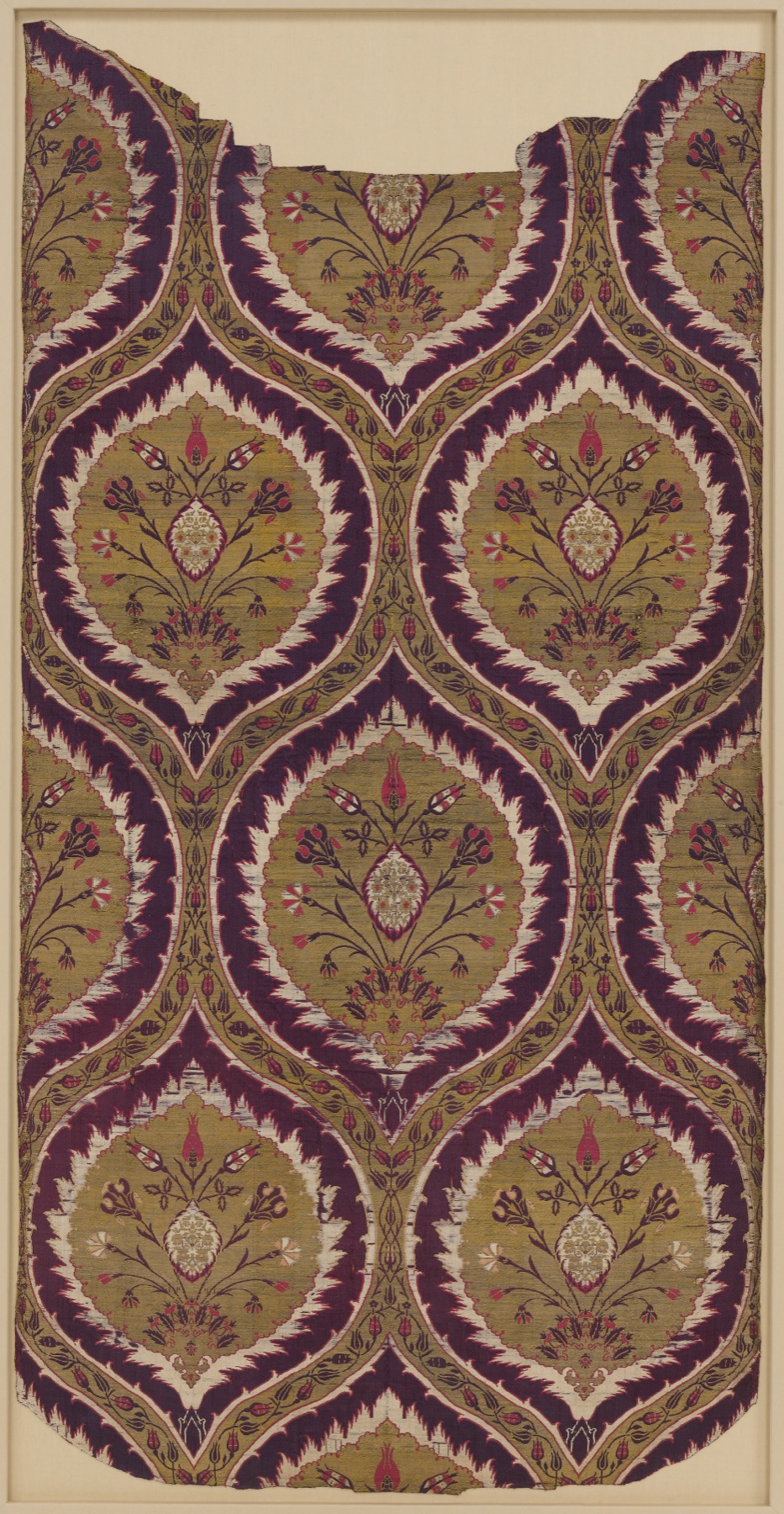 Fragmentary Ottoman silk loom width with an ogival lattice pattern of tulips and carnations in green, purple, and crimson